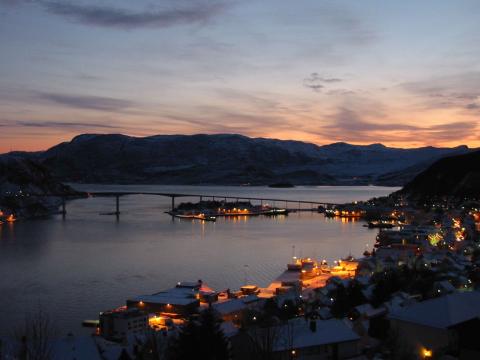 Måløy hamn i kveldstemning. I bakgrunnen Måløybrua som bitt saman Vågsøy med fastlandet. Innunder brua ligg Måløyna.
